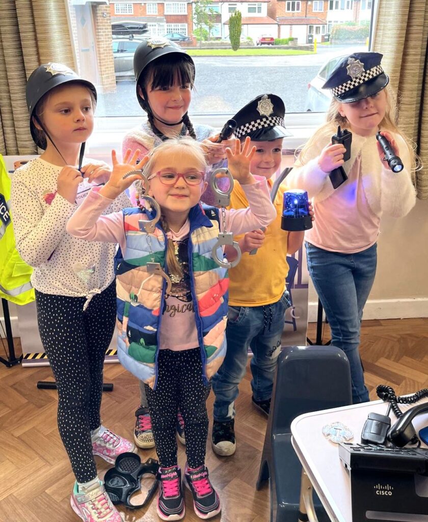 Children enjoying police officer role play at The Little Village of Imagination
